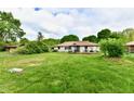 Wide-open backyard with a shed and mature trees offering privacy and shade at 135 Hickory Ct, Greenwood, IN 46142