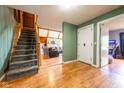 Inviting hallway featuring hardwood floors, staircase and an open view into the living room at 171 Williams Trce, Plainfield, IN 46168