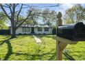 Inviting home exterior with a green lawn and vintage mailbox at 1903 Danbury Dr, Indianapolis, IN 46231