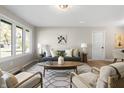 Bright living room with large windows, modern furniture, and stylish decor at 1903 Danbury Dr, Indianapolis, IN 46231