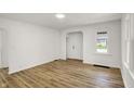Bright, newly renovated living room featuring modern wood floors, fresh paint, and plenty of natural light at 2015 S Hackley St, Muncie, IN 47302