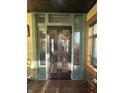 Elegant entryway with glass paneled doors, showcasing stylish decor and a glimpse into the living spaces at 2119 S Garfield Dr, Indianapolis, IN 46203