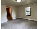 Inviting living room featuring neutral paint, carpeting, and a window bringing in natural light at 2271 Park Ave, Columbus, IN 47201
