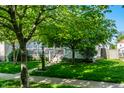 Quaint home with a welcoming front porch framed by mature trees and lush lawn at 2306 Alabama St, Indianapolis, IN 46205