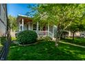 Charming home with a covered front porch and landscaped front yard at 2306 Alabama St, Indianapolis, IN 46205