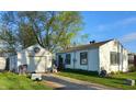 This image shows a detached garage next to the side of the house and its yard at 2315 E 3Rd St, Anderson, IN 46012