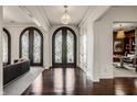 Welcoming foyer with dark hardwood floors and ornate glass-paneled doors at 2377 Finchley Rd, Carmel, IN 46032