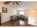 Bright living room with laminate floors, beamed ceilings, neutral walls, and gray sofas at 3131 Stillmeadow Dr, Indianapolis, IN 46214