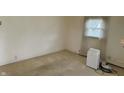 Well lit bedroom features neutral carpet, window with sheer curtains, and clean walls at 318 Elva St, Anderson, IN 46013