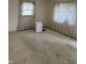 Spacious bedroom with carpet and window with sheer curtains at 318 Elva St, Anderson, IN 46013