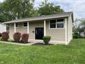 Charming two-story home with landscaped front yard, and inviting entryway with large columns at 3720 E Southern Ave, Indianapolis, IN 46203