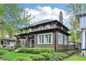 Exterior shot showcasing the architectural details and well-maintained landscaping of this lovely home at 4169 Central Ave, Indianapolis, IN 46205