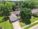 Aerial view of home showcasing its location among lush trees and manicured lawns in a suburban neighborhood at 4611 29Th St, Columbus, IN 47203