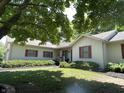 Traditional home with a covered front porch, shutters, landscaping, and green lawn at 4611 29Th St, Columbus, IN 47203