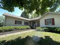 Traditional home with a covered front porch, shutters, landscaping, and green lawn at 4611 29Th St, Columbus, IN 47203