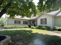 Traditional home with a covered front porch, shutters, landscaping, and green lawn at 4611 29Th St, Columbus, IN 47203