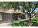 Two-story townhouse with brown siding and a mature tree casting shade on the lawn at 5177 Fairway Dr, Avon, IN 46123