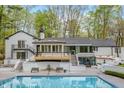 Stunning backyard featuring a pool, patio, and staircase to an upper deck with wood railings at 5190 Potters Pike, Indianapolis, IN 46234