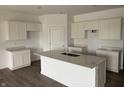 Modern kitchen with large island, granite countertops, stainless sink, and plenty of cabinet space at 5204 Cartland Dr, Indianapolis, IN 46239