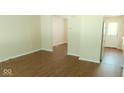 Bright living room featuring hard surface floors and a doorway leading to the kitchen at 5415 Wagon Wheel Trl, Indianapolis, IN 46237