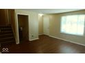 Spacious living area with a staircase, ample natural light, and neutral paint at 5415 Wagon Wheel Trl, Indianapolis, IN 46237