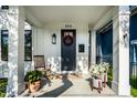 Inviting front porch with rocking chair, potted plants, and stylish front door with wreath at 544 N Beville Ave, Indianapolis, IN 46201