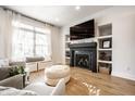 Bright living room with fireplace, shelving, large window, and comfortable seating at 544 N Beville Ave, Indianapolis, IN 46201