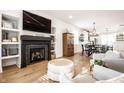 Modern living room featuring a sleek fireplace, built-in shelves, and hardwood floors at 544 N Beville Ave, Indianapolis, IN 46201
