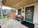 Inviting front porch with seating, perfect for relaxing, and charming exterior details at 5450 E 18Th St, Indianapolis, IN 46218