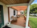 Relaxing outdoor wood deck with a pergola offers a charming space to unwind and enjoy the weather at 5450 E 18Th St, Indianapolis, IN 46218