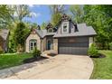 Attractive home showcasing stone and siding, complemented by a neatly paved driveway at 5548 Painted Maple Ct, Indianapolis, IN 46254