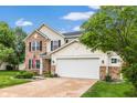 Attractive two-story home with a two-car garage, manicured lawn, brick details, and classic curb appeal at 5617 Gainesway Dr, Greenwood, IN 46142