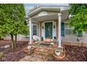Welcoming front porch featuring brick accents, decorative statues, and a quaint seating area at 5750 W 650 N, Thorntown, IN 46071
