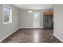 Eat-in kitchenette has stainless steel appliances, wood cabinets, laminate flooring and large picture window at 6231 W Clinton St, Stilesville, IN 46180
