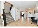 Bright and open foyer featuring a staircase, wood floors, and inviting decor at 6398 Marden Trl, Brownsburg, IN 46112