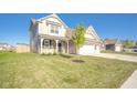 Charming two-story home with a well-manicured lawn and inviting curb appeal on a sunny day at 657 Kilmore Dr, Pendleton, IN 46064