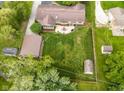 Expansive backyard with lush lawn, patio area, outbuilding, and partial fencing, offering privacy and space at 7135 Lantern Rd, Indianapolis, IN 46256