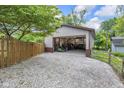 Large outbuilding with an open garage door and gravel driveway, providing ample space for storage at 7135 Lantern Rd, Indianapolis, IN 46256