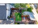 Aerial view of a private fenced backyard with deck, patio, fire pit and mature trees at 715 Terrace Ave, Indianapolis, IN 46203