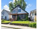 Charming two-story home featuring a welcoming front porch and nicely landscaped yard at 715 Terrace Ave, Indianapolis, IN 46203