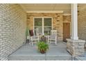 Inviting front porch with two rocking chairs, perfect for enjoying the outdoors at 7897 Hickory Ridge Ln, Mooresville, IN 46158