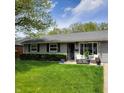 Charming single-story home with well-manicured lawn, inviting entrance, and tidy landscaping at 8136 E 37Th Pl, Indianapolis, IN 46226