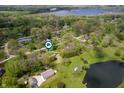 Aerial view of a home surrounded by lush greenery, ponds, and located in a serene neighborhood at 8245 Woodlawn Dr, Martinsville, IN 46151