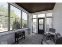 Inviting sunroom featuring brick walls, many windows and comfortable seating for enjoying the outdoors at 825 Iowa St, Indianapolis, IN 46203