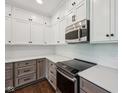 Modern kitchen showcasing stainless steel appliances, granite countertops, and stylish white backsplash at 877 Rosalind Pl, Carmel, IN 46032