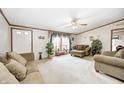 Comfortable living room featuring neutral tones, plush seating, bright windows, and a ceiling fan at 9660 B Old Haggard Rd, Morgantown, IN 46160