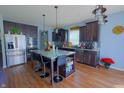Modern kitchen with stainless steel appliances, dark cabinets, and a center island with seating at 9993 Pepper Tree Ln, Noblesville, IN 46060