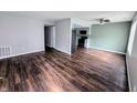 Bright living room with dark wood floors, neutral walls, and open to a modern kitchen at 10063 Penrith Dr, Indianapolis, IN 46229