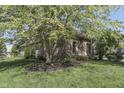 A tranquil property showing a side exterior, and mature trees on a well-kept lawn at 1014 Massey Ct, Greenwood, IN 46143