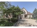 Charming brick home with a three-car garage and lush landscaping, set against a clear blue sky at 1014 Massey Ct, Greenwood, IN 46143